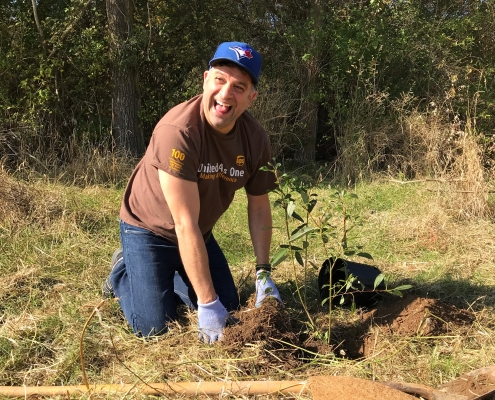 UPS employee planting a tree for a corporate tree planting